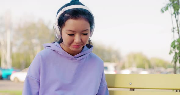 Asian Woman Freelancer Outdoors Working on Laptop