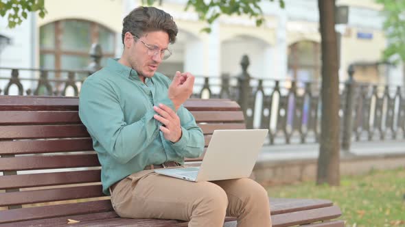 Man having Wrist Pain while Working on Laptop