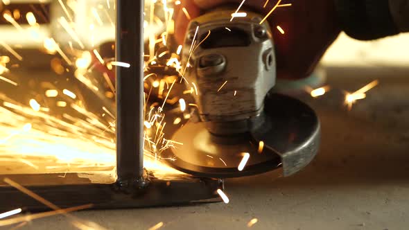 Angle Grinder Smoothes the Weld