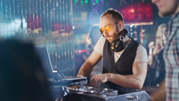 DJ is Playing Music at a Party in a Nightclub