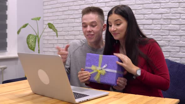 Cute Couple Give Present To Family By Video Call Online Holiday Celebration