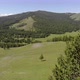 Green Meadows in The Sparsely Wooded Between Forest Covered Hills with Aerial View - VideoHive Item for Sale
