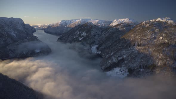 Timelapse with rolling fog and rising sun in beautiful Norwegian fjord