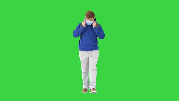 Schoolboy with Backpack Wearing Medical Mask Walking on a Green Screen Chroma Key