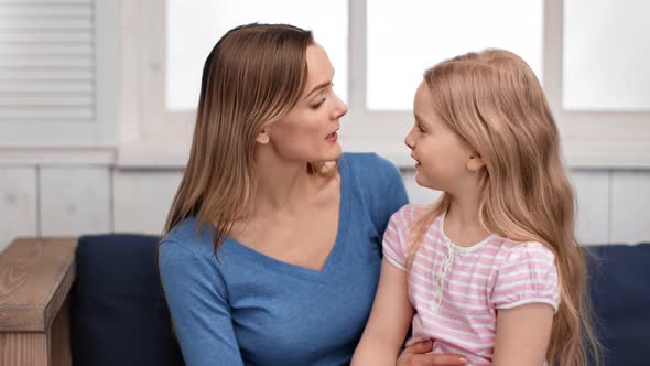 Mother Talking with Cute Daughter Playing Touching Nose