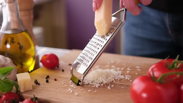 Making Pasta Carbonara  Grating Parmesan Cheese on Wooden Cutting Board