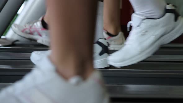 Feet running treadmills cardio workout exercise in gym