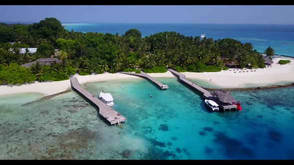 Aerial top down texture of perfect resort beach vacation by transparent lagoon with clean sand backg