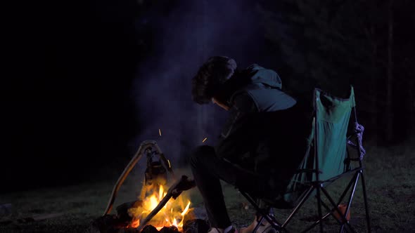 The man camping at night.