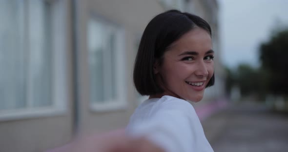 Carefree Girl Walking on the Street Following Me Holding Hands