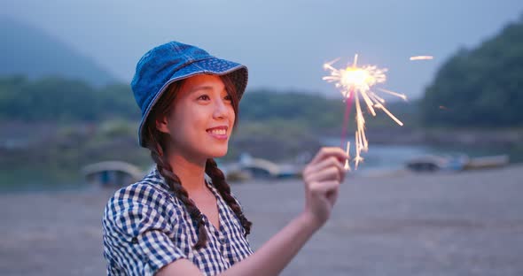 Woman play with sparklers in the summer time at outdoor