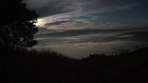 Time lapse shot of clouds on top of hill