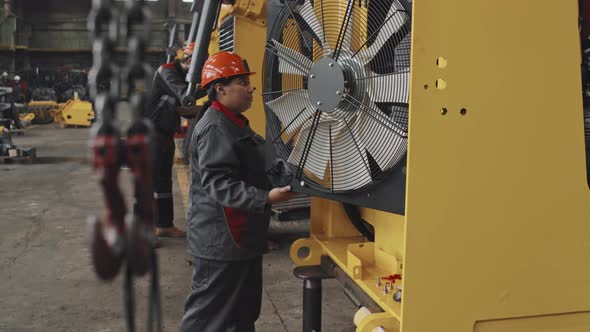 Technician Inspecting Produced Machinery