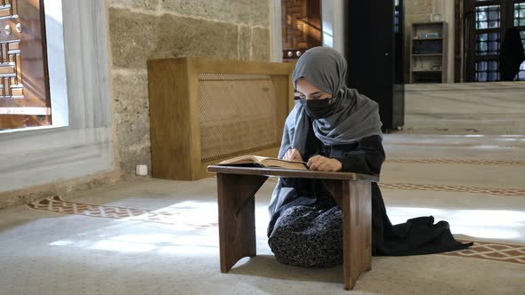 Worship to God Masked Muslim Woman Reading Islamic Holly Book Quran