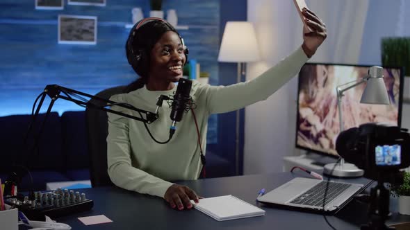 African Woman Blogger Portrait Taking Pictures of Herself on Smartphone