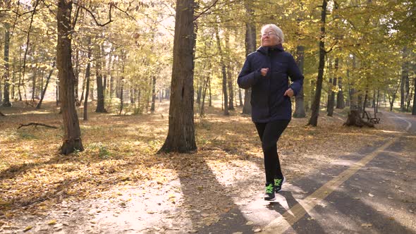 Sporty Elderly Woman During Outdoor Cardio Workout