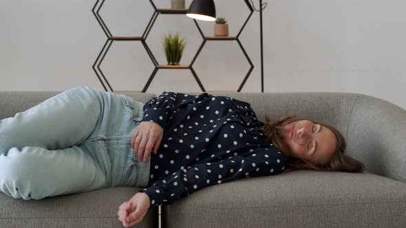 Tired Caucasian Woman Falls in the Sofa Exhausted Businesswoman in Living Room at Home