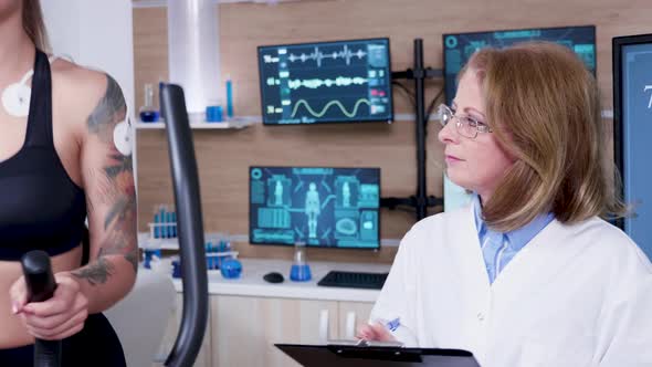 Female Doctor in Sport Science Working with Beautiful Female Athlete