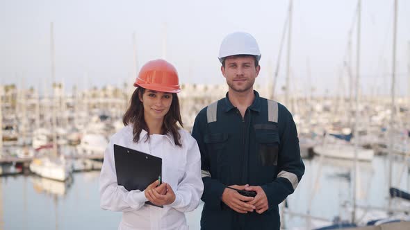 Woman and Man Yacht Sailors Standing at Marina