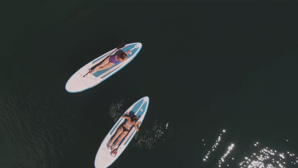 Female Friends Surfing on Sup Board