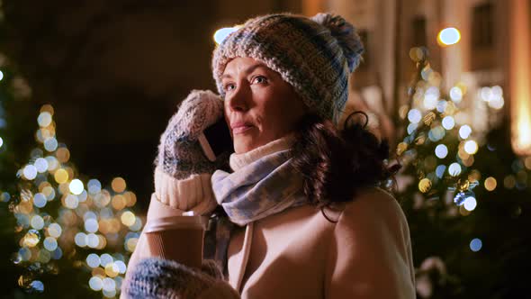 Happy Woman Calling on Smartphone on Christmas