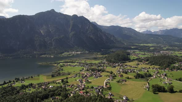 Aerial view of the village, lake, fields and forest in mountains Alps Austria