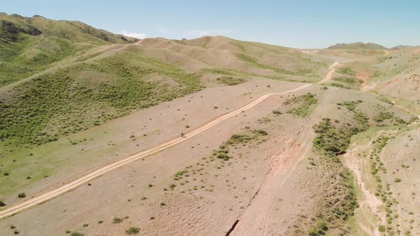 Drone Shot of Bicyclist Ride in the Mountains of Kazakhstan