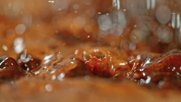 Super Slow Motion Macro Shot of Splashing Fresh Coffee and Water Droplets at 1000 Fps.