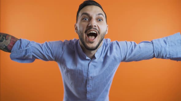 Young Man Showing with Outstretched Arms and Screaming Loud, Close Shot. Winner Concept