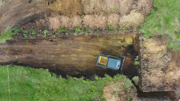 Bulldozer Digging Foundation Pit for New House in Countryside