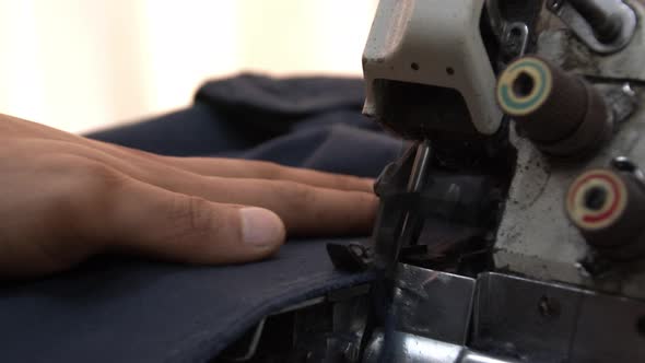 Tailor Mending Trousers With Overlock Sewing Machine 1