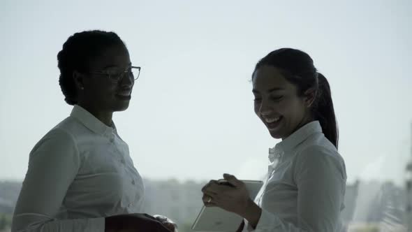 Serious Young Businesswomen with Digital Tablet 