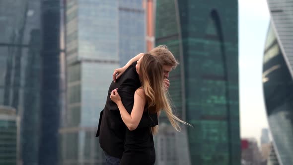 Young Woman and Middle Aged Man Are Embracing in City, Urban Landscape