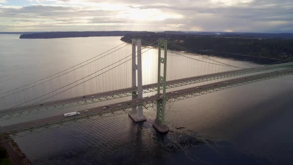 Wide aerial shot pulling away from Tacoma Narrows Bridge at sunset, circa 2015.