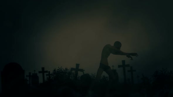 Male Zombie Walking Out Of His Grave In A Cemetery