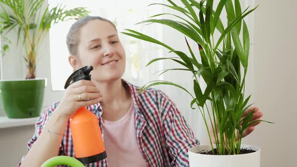 Portrait of Smiling Woman Taking Care of Flowers and Watering Plants at Home