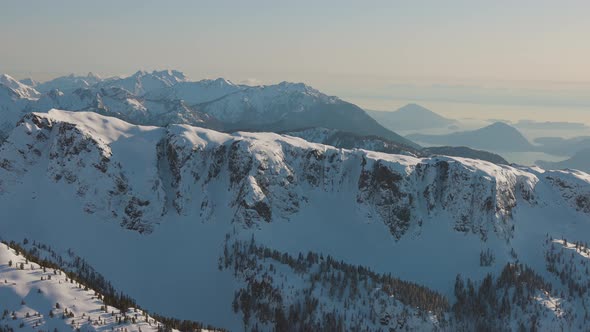 Aerial View From an Airplane of Beautiful Snowy Canadian Mountain Landscape