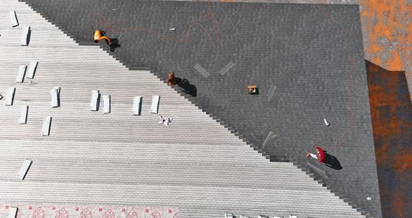 A Worker Installing Shingles on the Roof of a Home