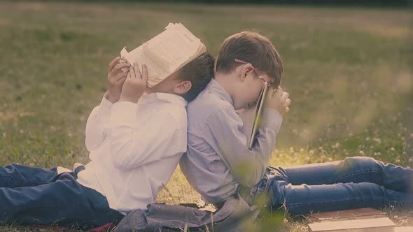 Boys Wearing Shirts and Jeans Relax After Hard Study Day