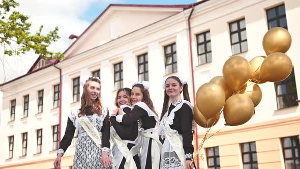 Happy Russian Female Graduates Pose on Their Graduation Day