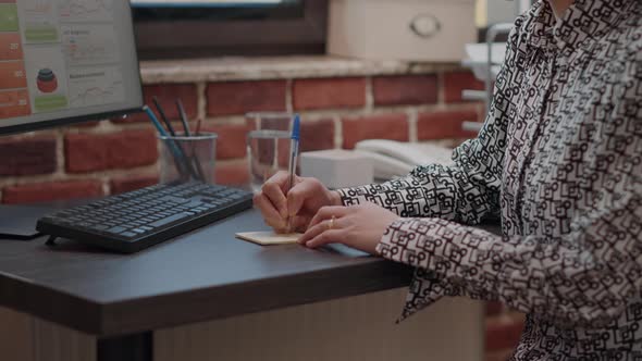 Close Up of Worker Putting Sticky Notes on Computer