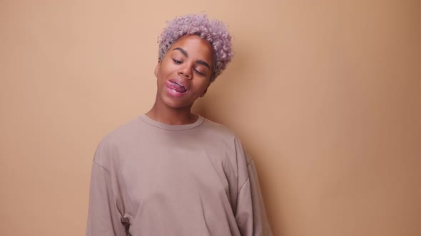 Cheerful African American Woman Fooling Around and Making Funny Face Sticking Out Tongue