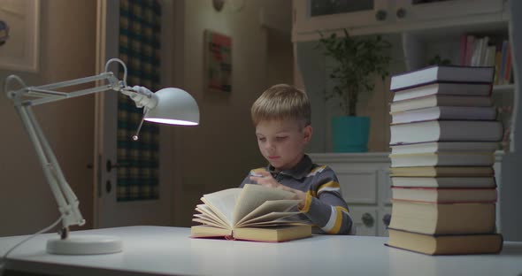 Preschool Child Tired of Reading Book and Falling Asleep on Book