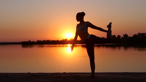 Yoga. Girl Raises a Leg Up