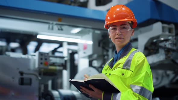 Woman Factory Worker Looking Camera Near Big Metal Manufacture Constructions