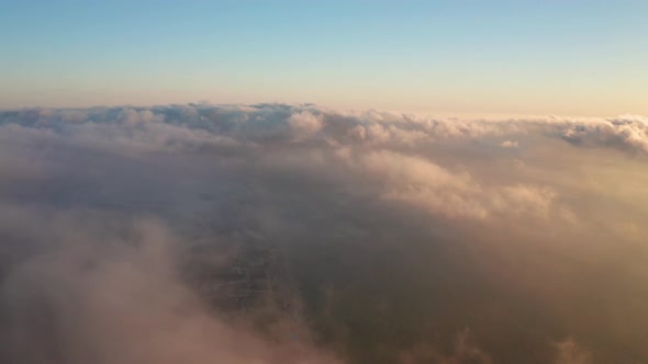 Aerial video over low clouds and morning fog alt