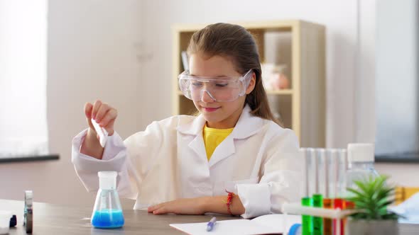 Girl with Test Tubes Studying Chemistry at Home