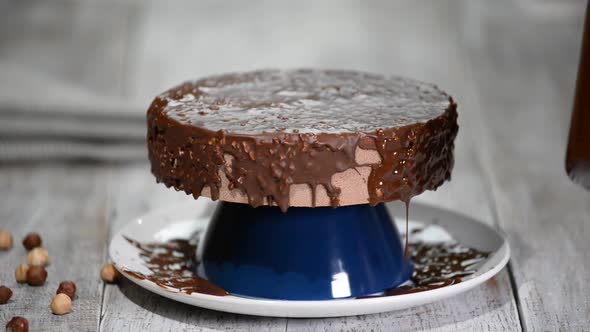 The chocolate icing on the froasted cake.Modern French mousse cake with chocolate glaze.	