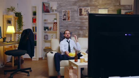 Businessman with Tie Relaxing on Couch After a Long Day at Work