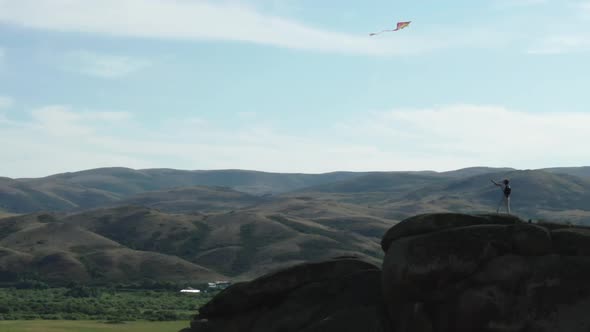 A Man With A Kite On The Mountain